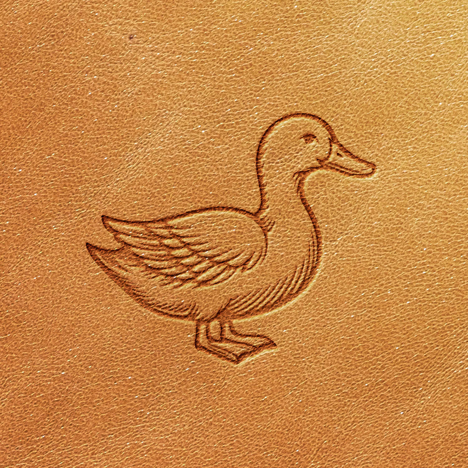 The Duck Head Delrin Leather Stamp creates an embossed illustration of a simple duck design on a textured, light brown leather surface, depicting its wings, beak, and webbed feet in a side profile view.