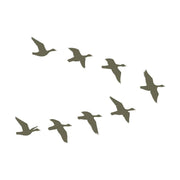 Silhouette of a flock of birds flying in a V-formation, representing migratory birds in motion.