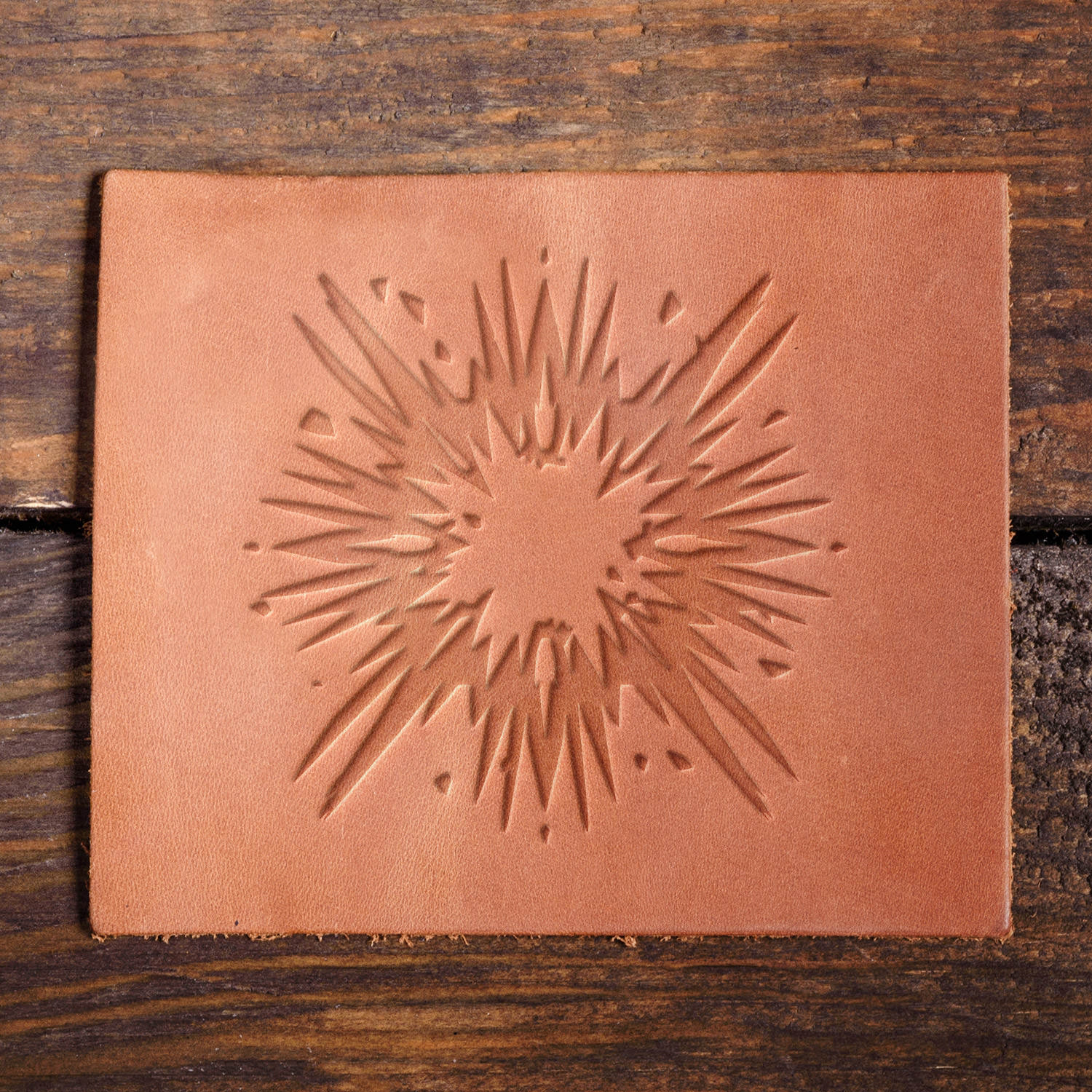 Leather sample with a crisp starburst stamp impression from a Delrin leather stamp, ideal for creating high-quality dynamic and decorative leathercraft projects.