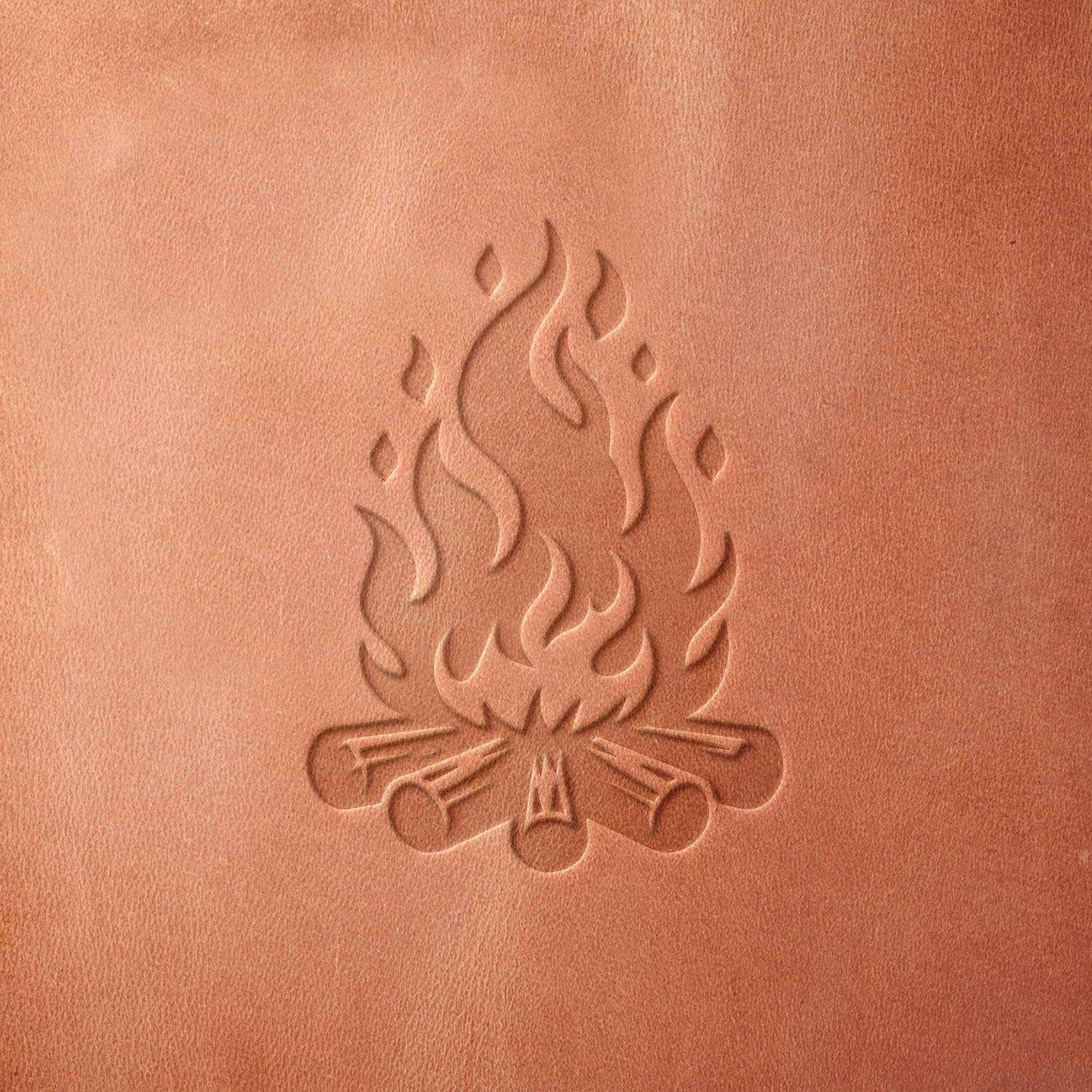 Leather sample showcasing a stamped campfire with dancing flames and detailed logs using a delrin leather stamp, ideal for outdoor and wilderness themes.