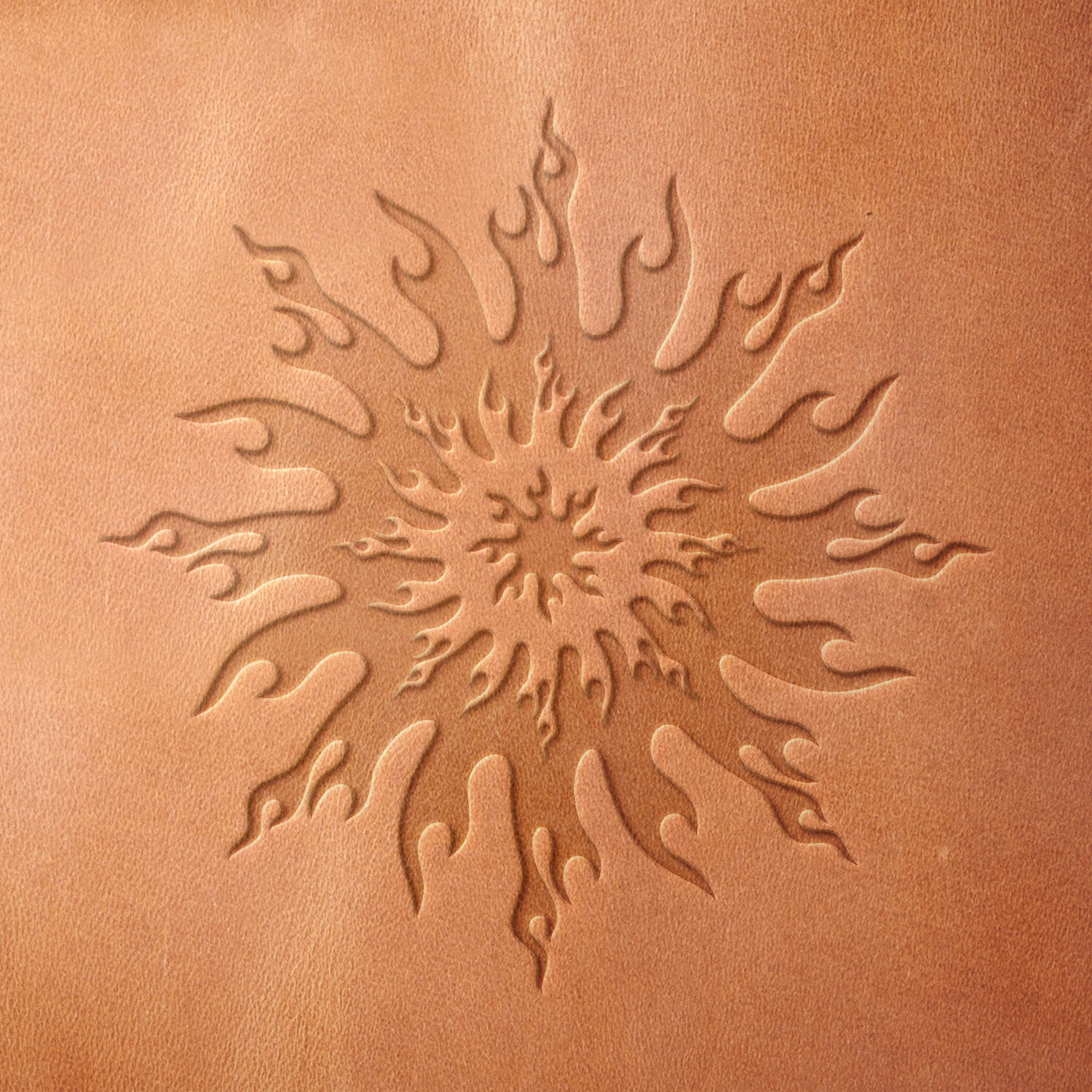 Leather sample showcasing a stamped flame sun design using a delrin leather stamp, highlighting the radiating rays and bold, symmetrical layout.