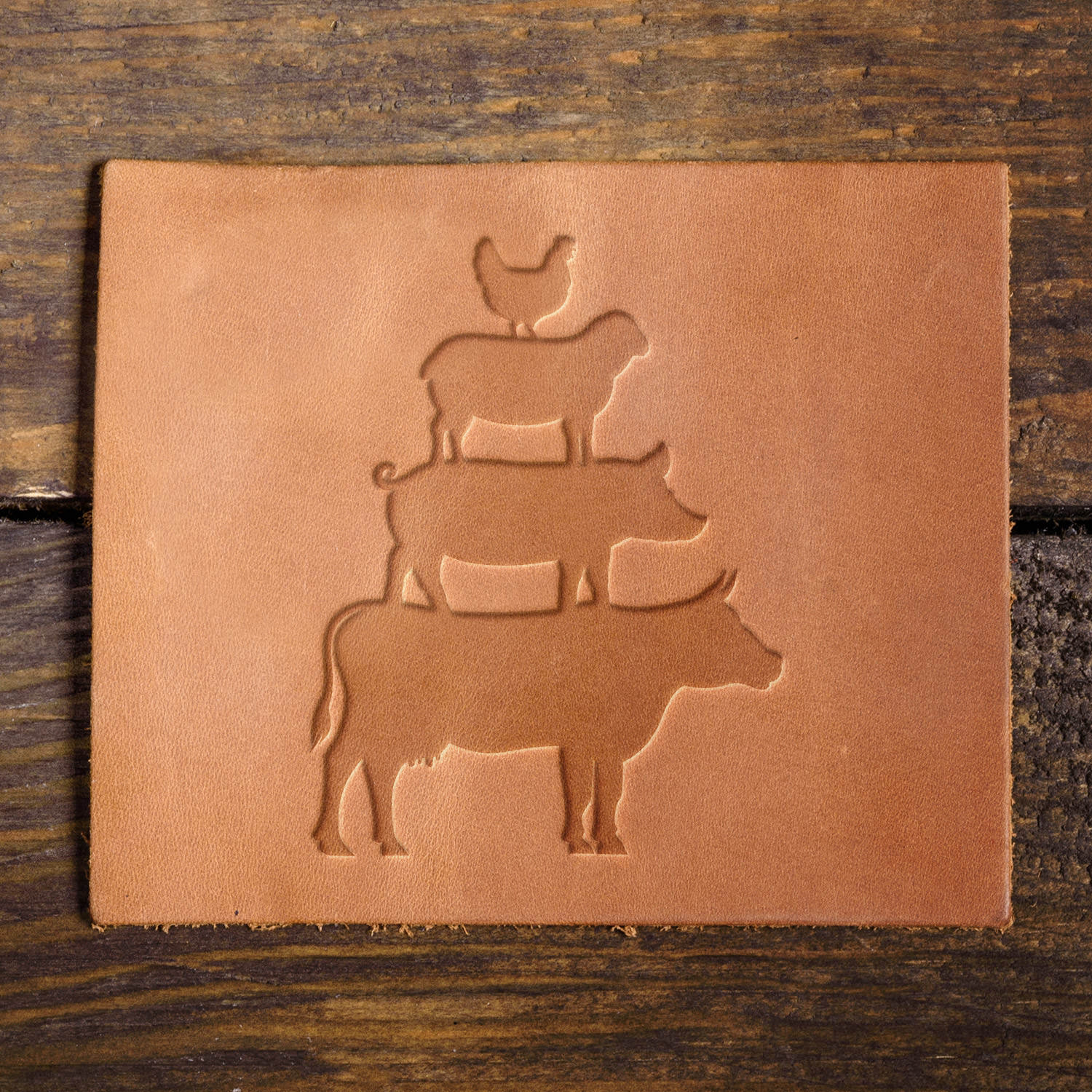 Leather sample with a stamped stacked farm animal design, perfect for rustic and farmhouse-themed leather goods.