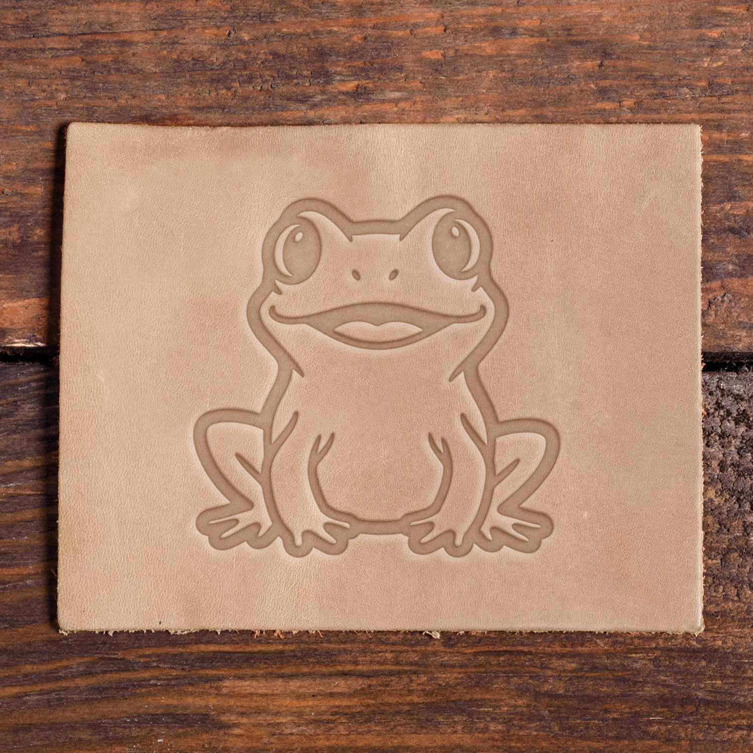 Leather sample with a stamped frog design using a Delrin leather stamp, ideal for nature or animal-themed leather projects.
