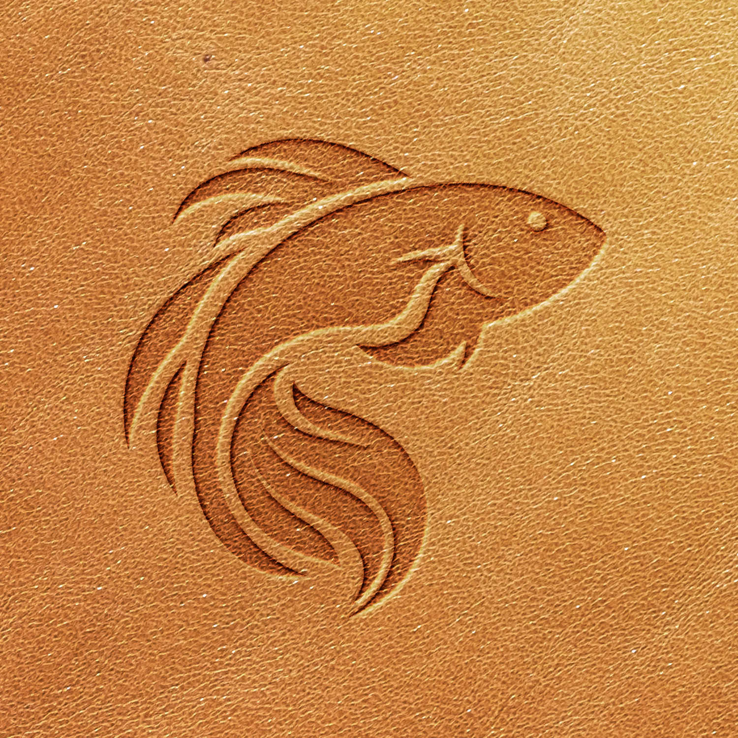 The Fish Delrin Leather Stamp creates an elegant, minimalist depiction of a fish embossed on light brown or tan leather. The design features smooth, curved lines representing the body, fins, and tail of the fish, resulting in a graceful and flowing appearance.