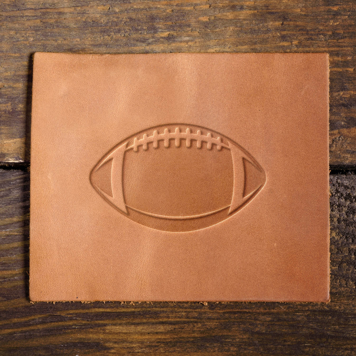 Leather sample with a crisp football stamp impression, adding a sporty and athletic touch to leather projects.