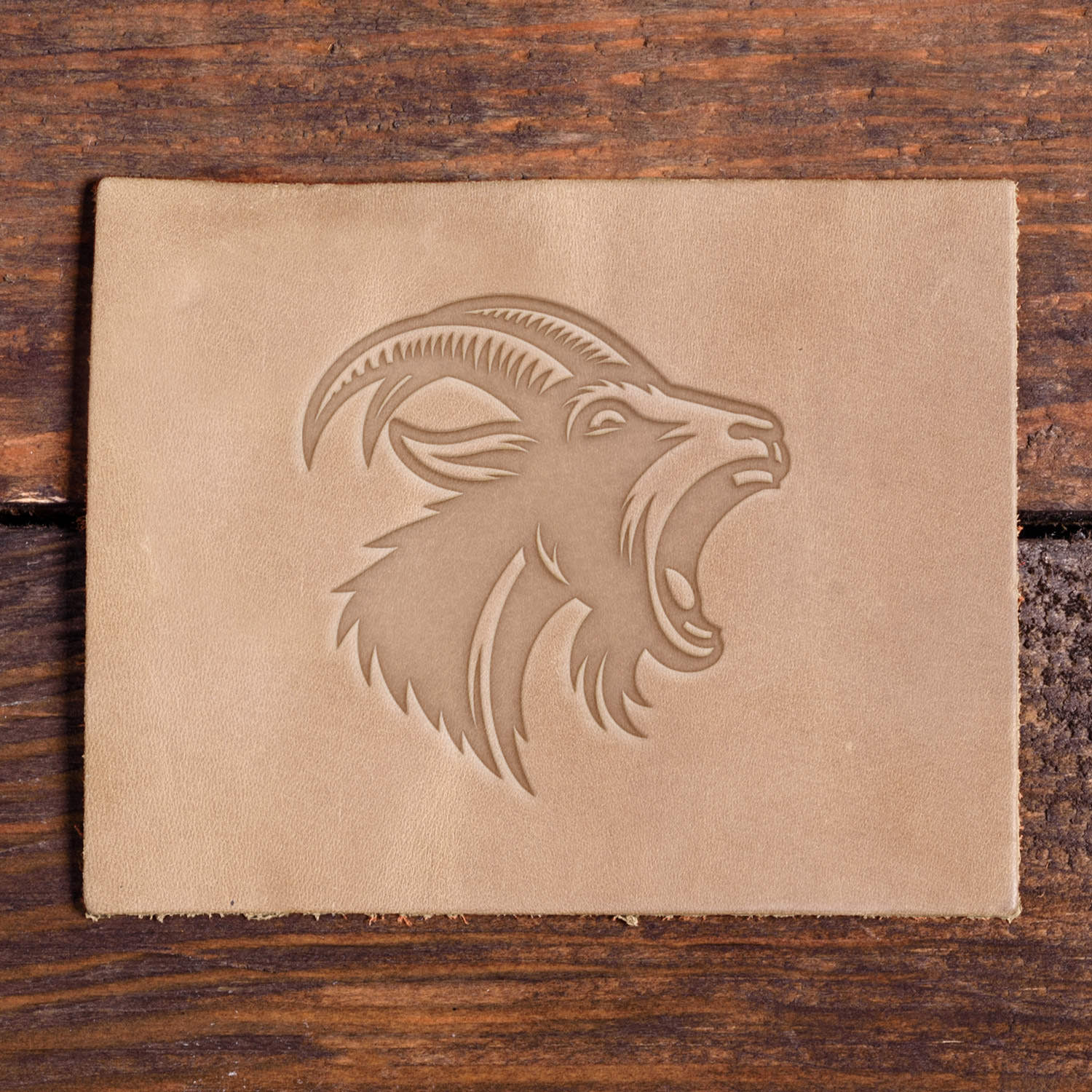 Leather sample with a stamped mountain goat design using a Delrin leather stamp.
