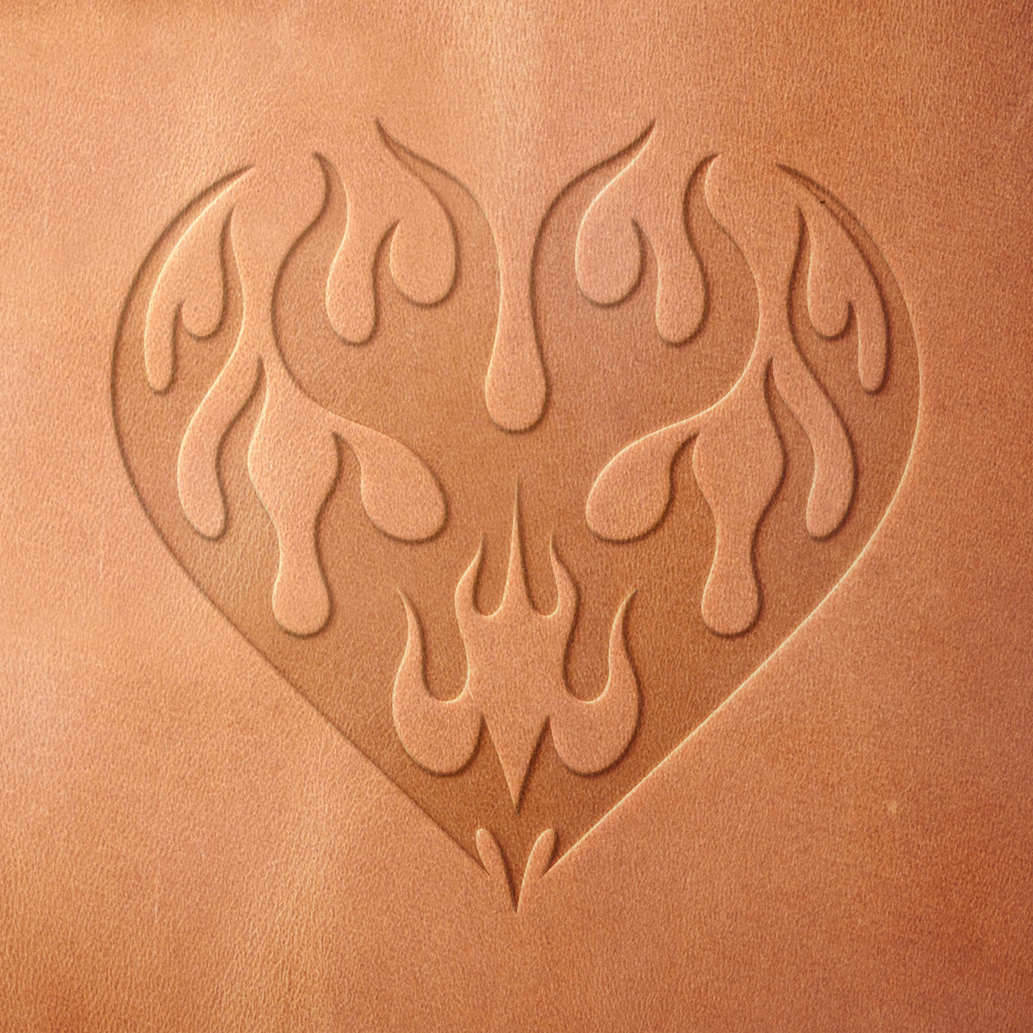 Leather sample showcasing a stamped flaming heart design using a delrin leather stamp, emphasizing the intricate flame details and strong symmetrical layout.