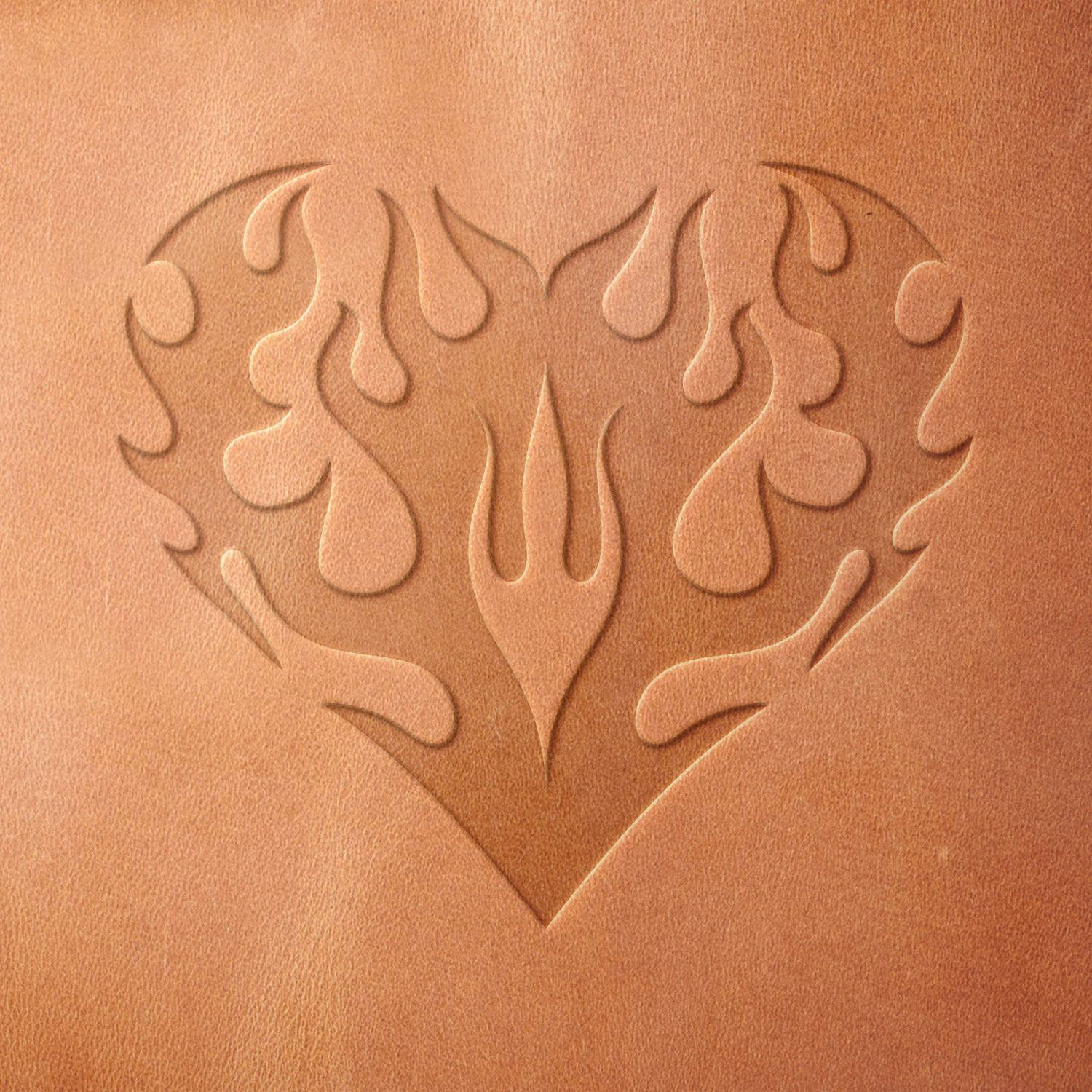 Leather sample showcasing a stamped flaming heart design using a delrin leather stamp, highlighting the bold lines and balanced symmetry.