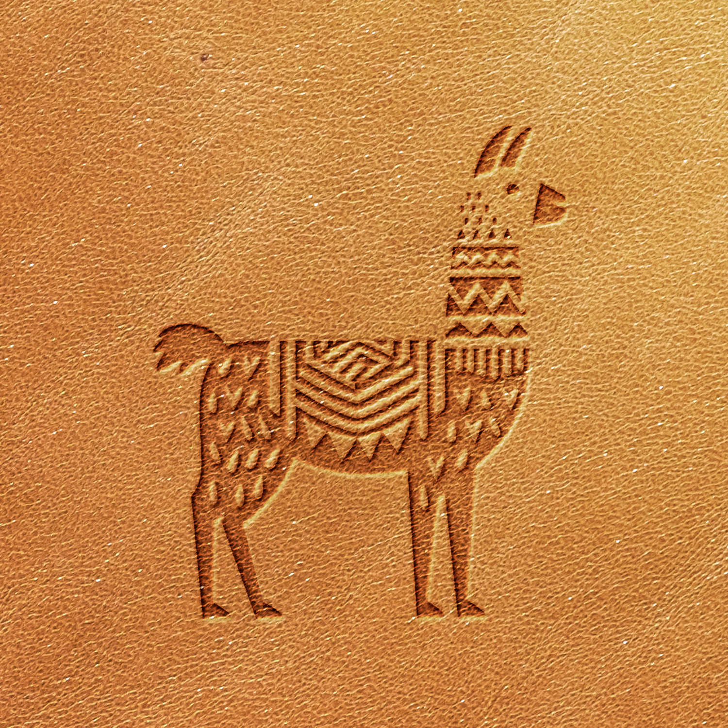 The Llama Delrin Leather Stamp features a llama embossed design on a tan leather surface. The llama is intricately stylized with geometric patterns, including triangles and lines, creating a textured appearance.