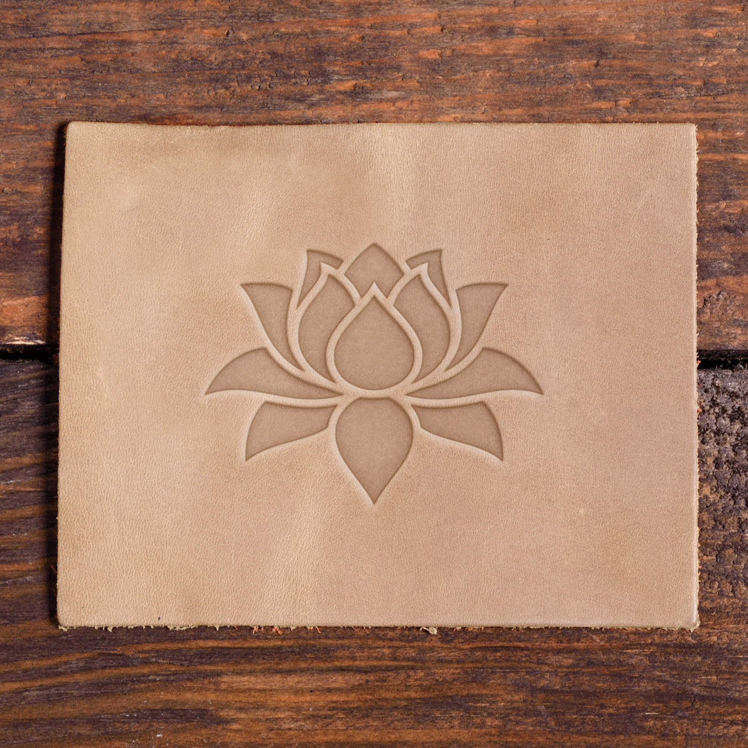 Leather surface stamped with a Delrin leather stamp featuring a crisp lotus flower impression—ideal for handmade goods with a calming, nature-inspired feel.