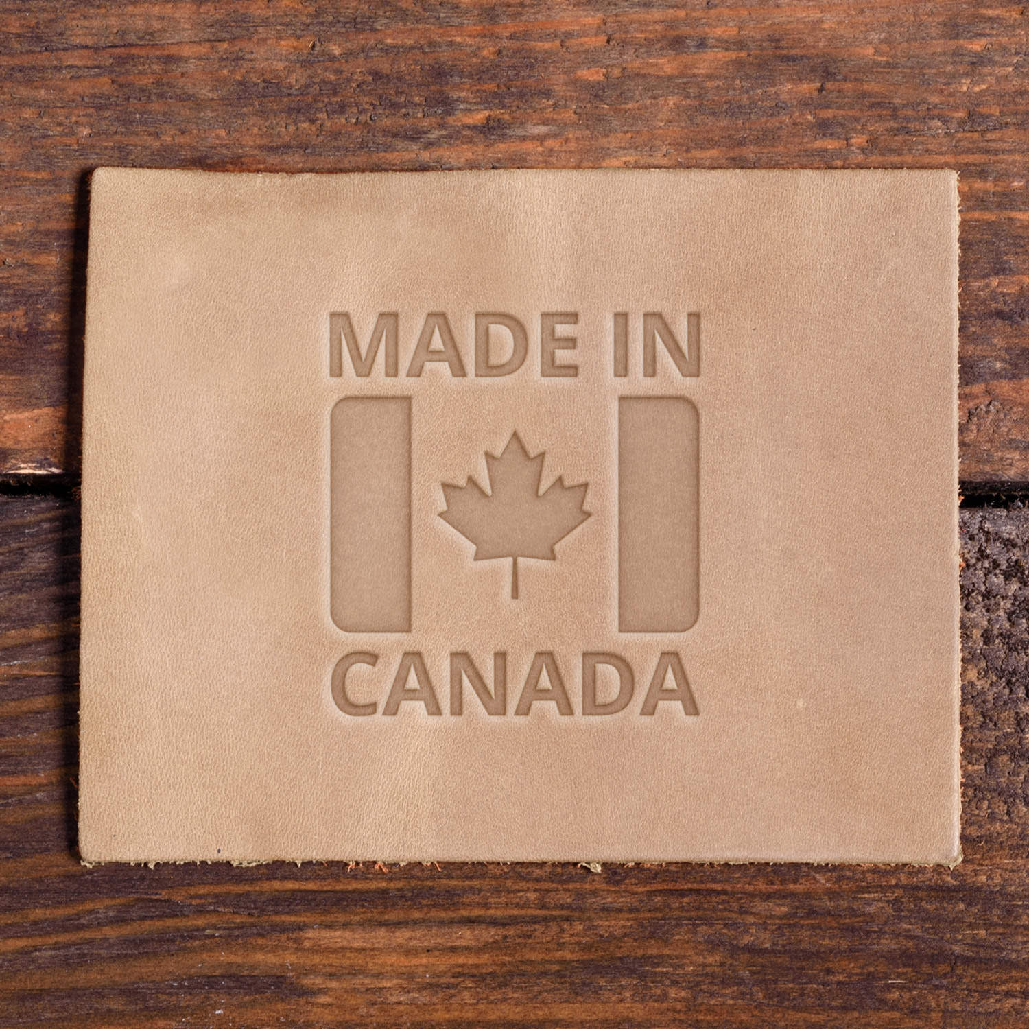 Leather swatch with made in Canada flag  with maple leaf and bold block lettering, made using a Delrin leather stamp
