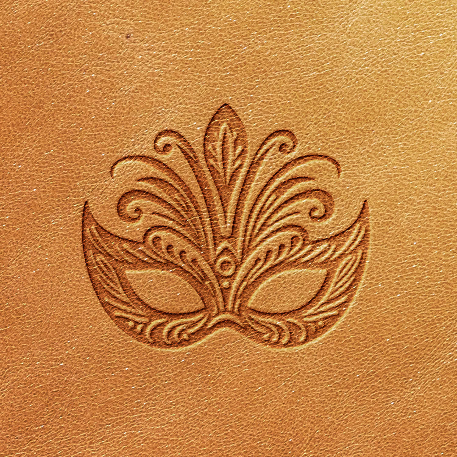 A detailed and ornate design, the Mardi Gras Mask Delrin Leather Stamp features an intricate mask embossed on a tan leather surface. The stamp delivers a pattern of curved lines and elaborate shapes, creating an elegant and decorative effect. The leather showcases a smooth texture and even color.