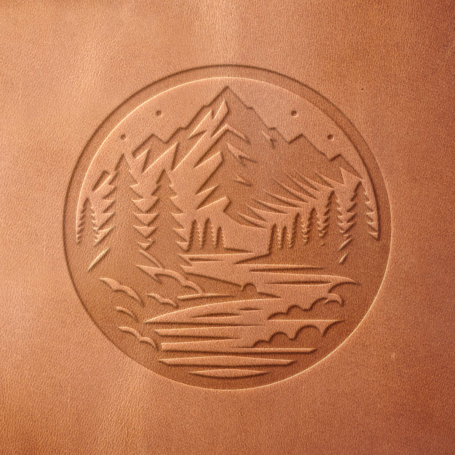 Leather sample with a crisp mountain landscape stamp impression from a Delrin leather stamp, ideal for creating high-quality nature and outdoor-themed leathercraft projects.