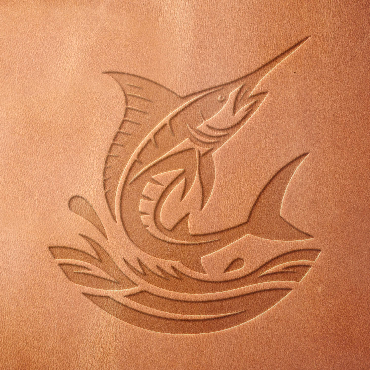 Leather sample with a crisp jumping marlin stamp impression from a Delrin leather stamp, ideal for creating high-quality fishing and ocean-themed leathercraft projects.