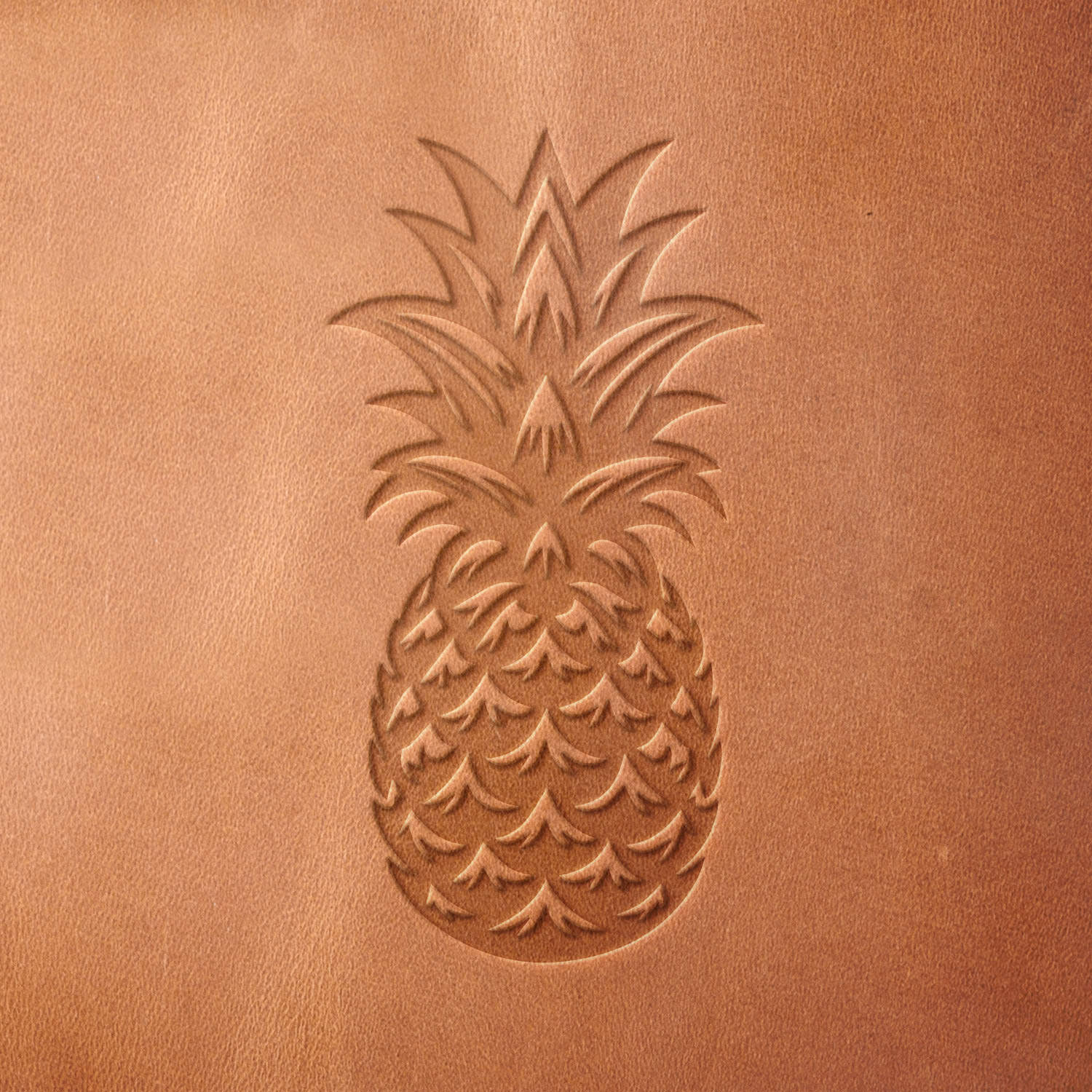 Leather sample with a crisp pineapple fruit stamp impression from a Delrin leather stamp, ideal for creating high-quality tropical and decorative-themed leathercraft projects.