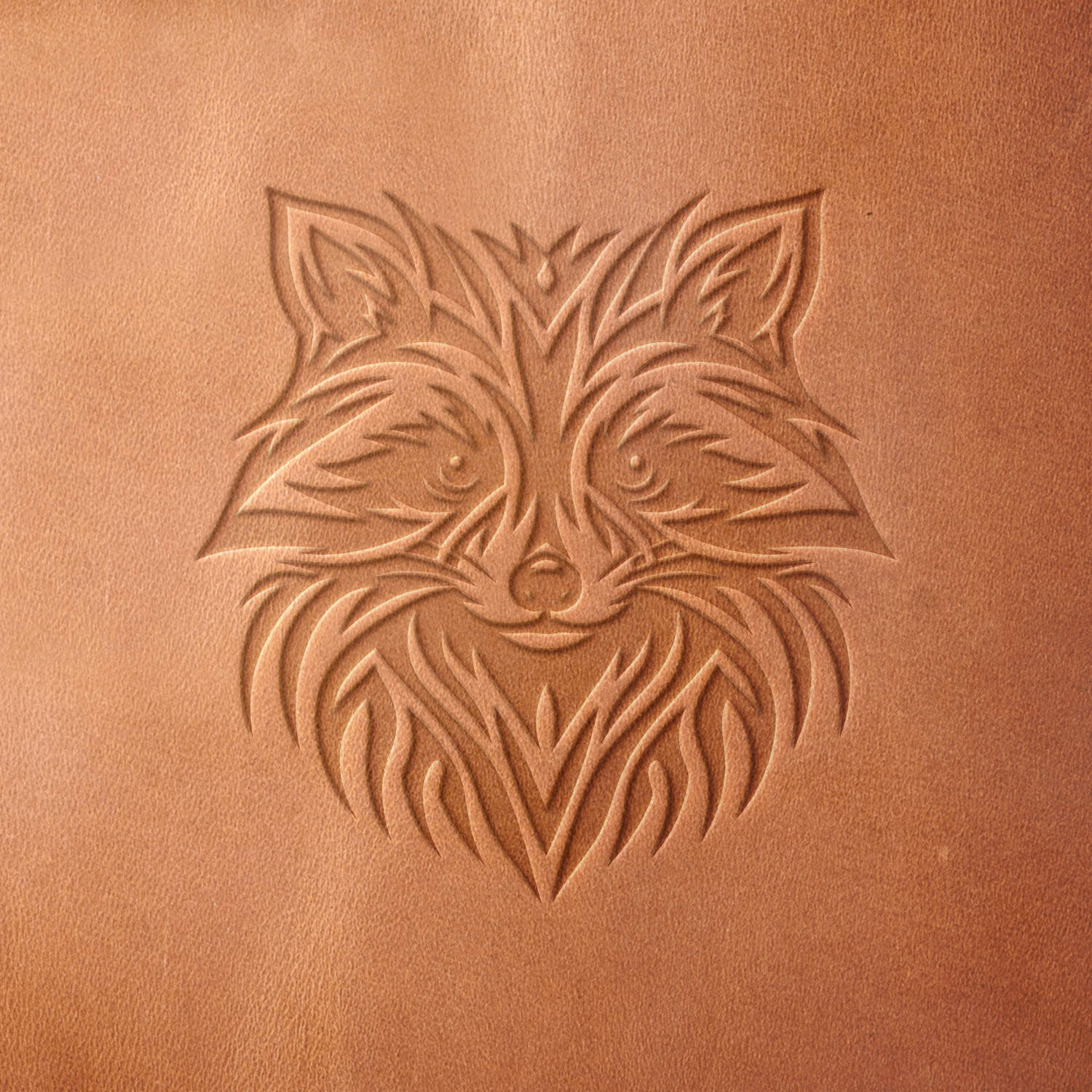 Leather sample with a crisp raccoon face stamp impression from a Delrin leather stamp, ideal for creating high-quality wildlife and nature-themed leathercraft projects.