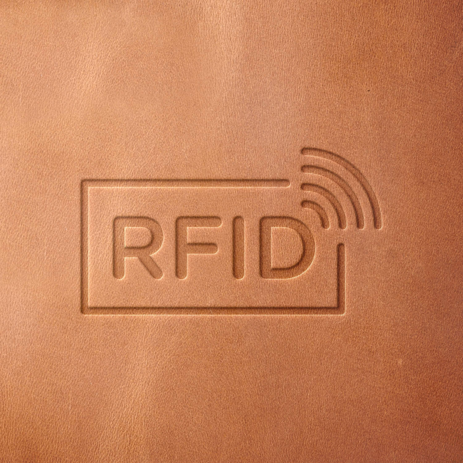 Leather sample with a crisp RFID symbol stamp impression from a Delrin leather stamp, ideal for creating high-quality RFID-blocking wallets and security-themed leathercraft projects.