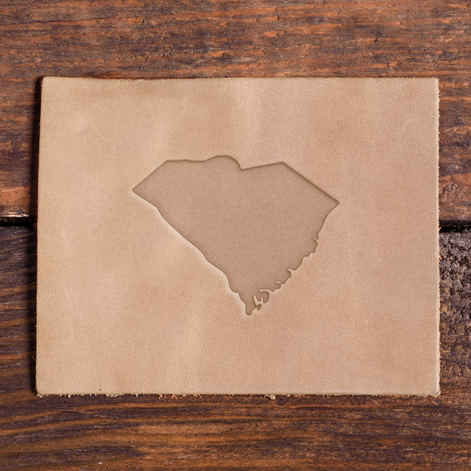 Leather piece stamped with a Delrin leather stamp design of South Carolina’s state outline.