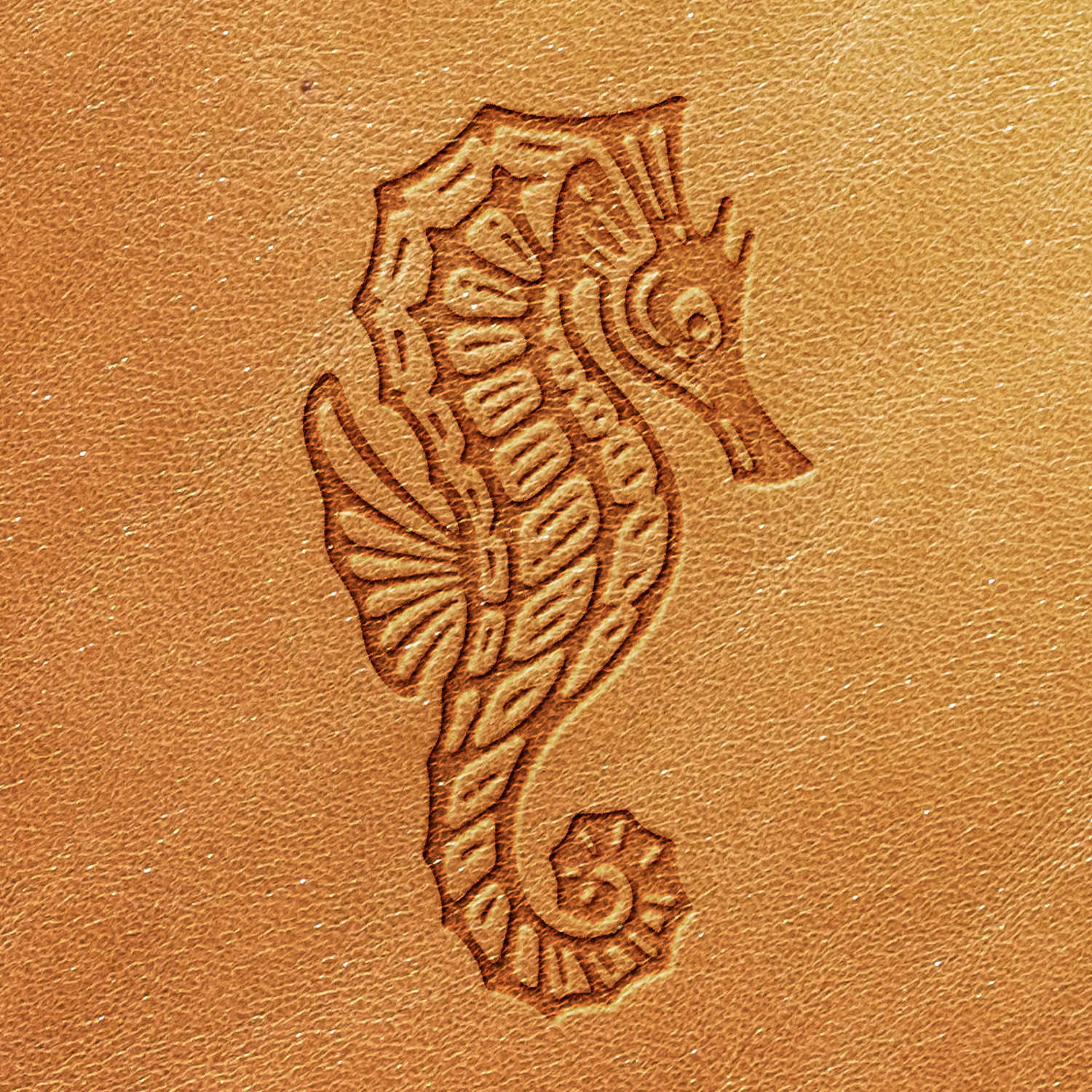 The Seahorse Delrin Leather Stamp intricately carves a detailed seahorse design into tan leather, showcasing the seahorse's body, fins, and curled tail with elaborate patterns. The smooth leather retains its light, natural hue after stamping.