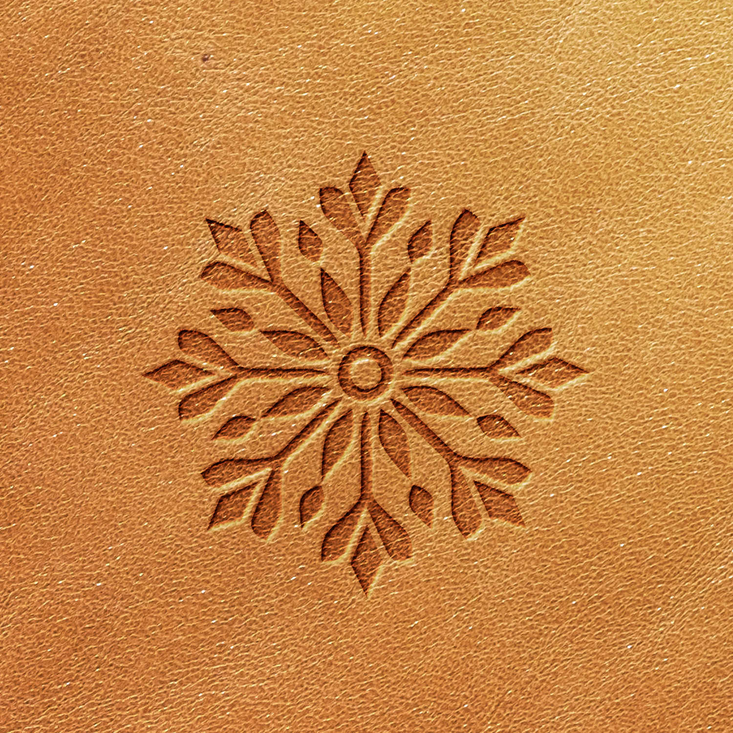 The Snowflake Delrin Leather Stamp creates a luxurious snowflake pattern on a rich brown leather surface. The symmetrical design features intricate branches, crafting a textured and decorative appearance on the leather.