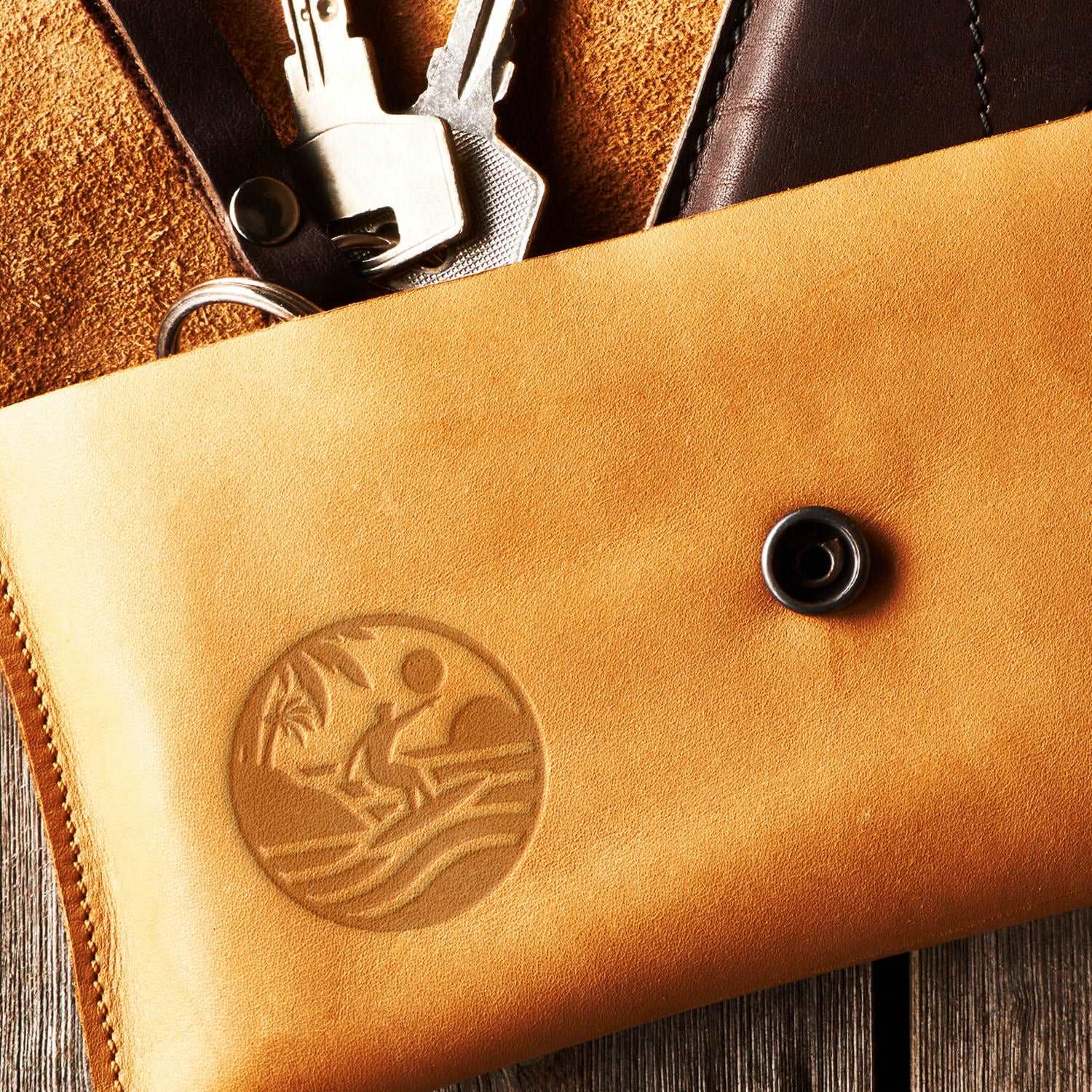 Leather wallet featuring a surfer design stamped with a Delrin tool, perfect for creating beach and ocean-themed leather crafts