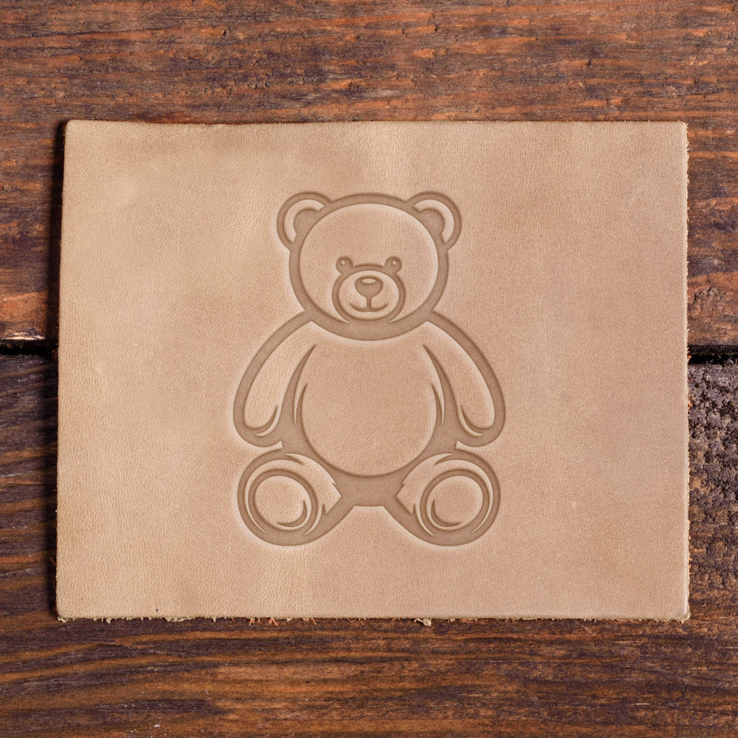 Leather sample with a stamped teddy bear design using a Delrin leather stamp, ideal for baby, kids, or gift-themed leather projects.
