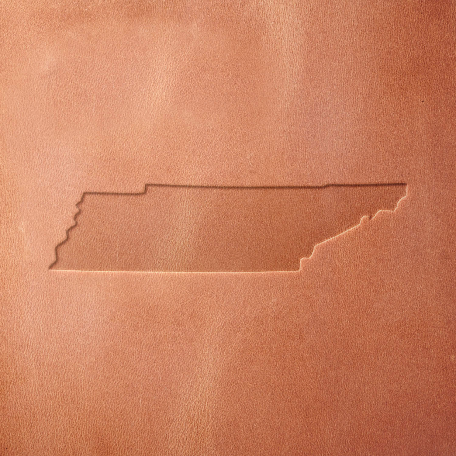 Leather impression of Tennessee's state outline, created with a Delrin leather stamp. The crisp edges and accurate state shape make it perfect for custom leathercraft projects.