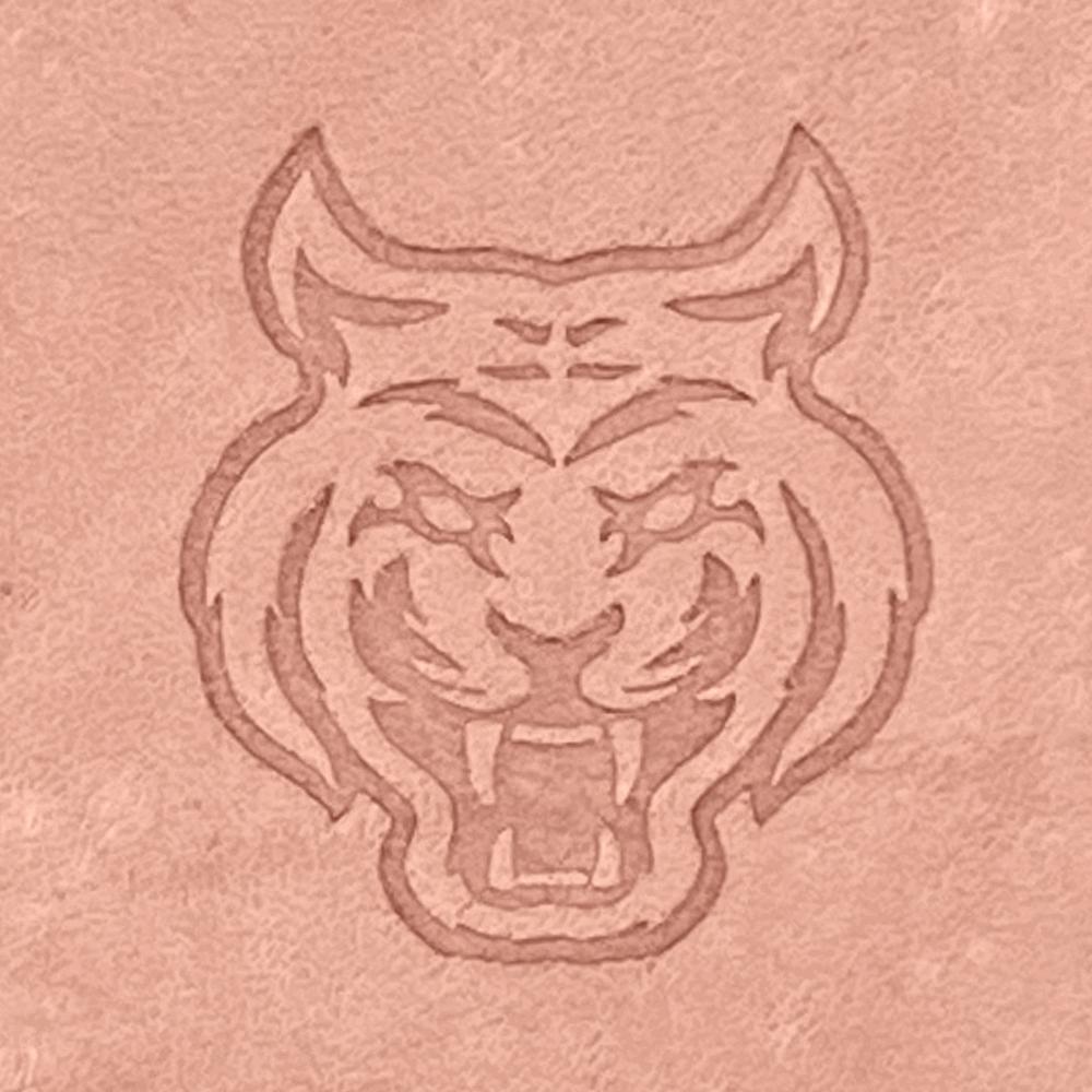 Natural veg-tan leather stamped with a fierce tiger head design using a Delrin leather stamp, showing strong lines and expressive detail.