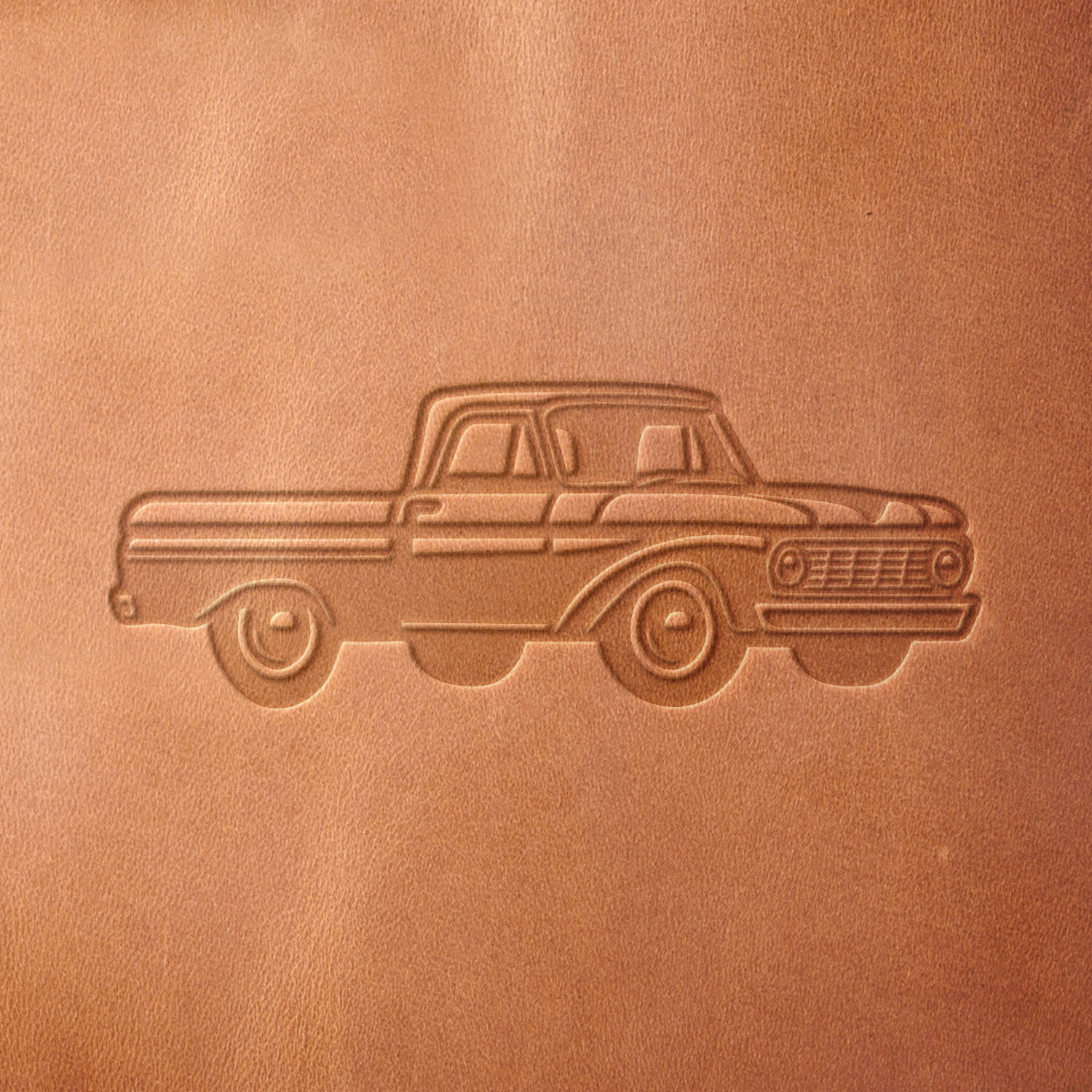 Leather sample with a crisp vintage pickup truck stamp impression, ideal for adding a nostalgic automotive touch to leather projects.