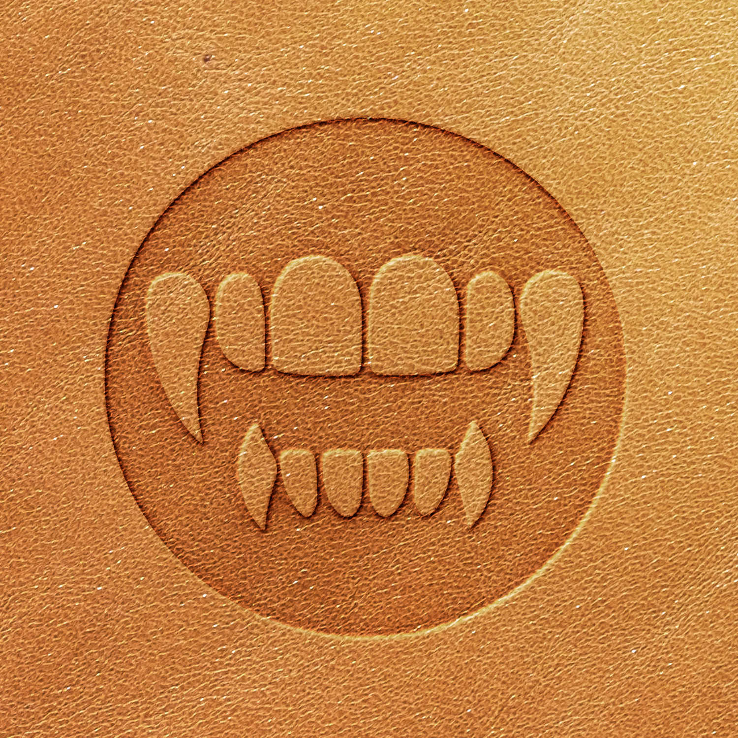 A close-up of a light brown leather texture featuring the embossed design created with the Vampire Teeth Delrin Leather Stamp, showcasing stylized vampire fangs and teeth.