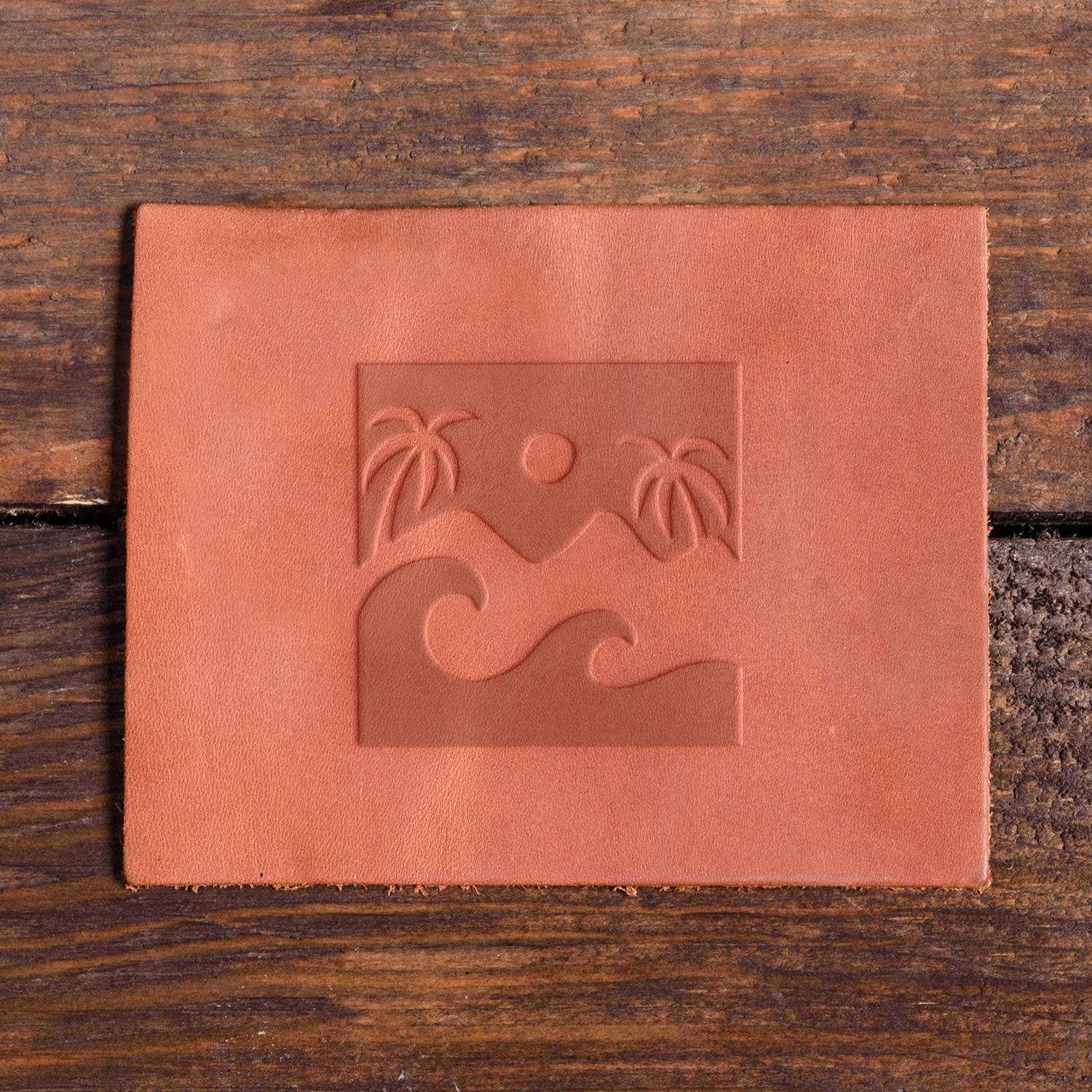 Leather piece featuring a tropical landscape design stamped with a Delrin tool, perfect for creating beach and nature-themed leather crafts