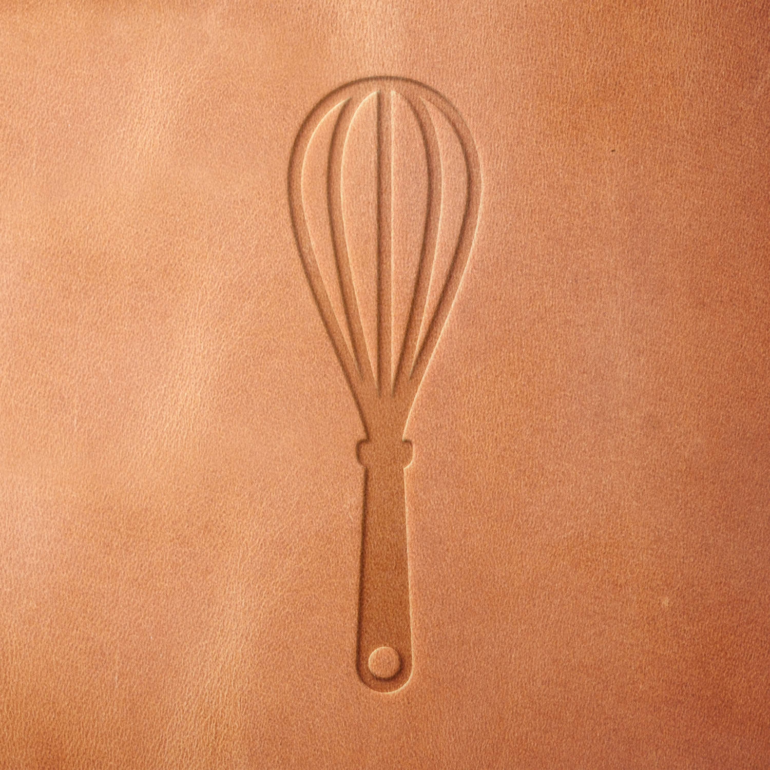 Leather sample showcasing a stamped whisk design using a delrin leather stamp, highlighting the whisk’s simple wire loops and handle detail.