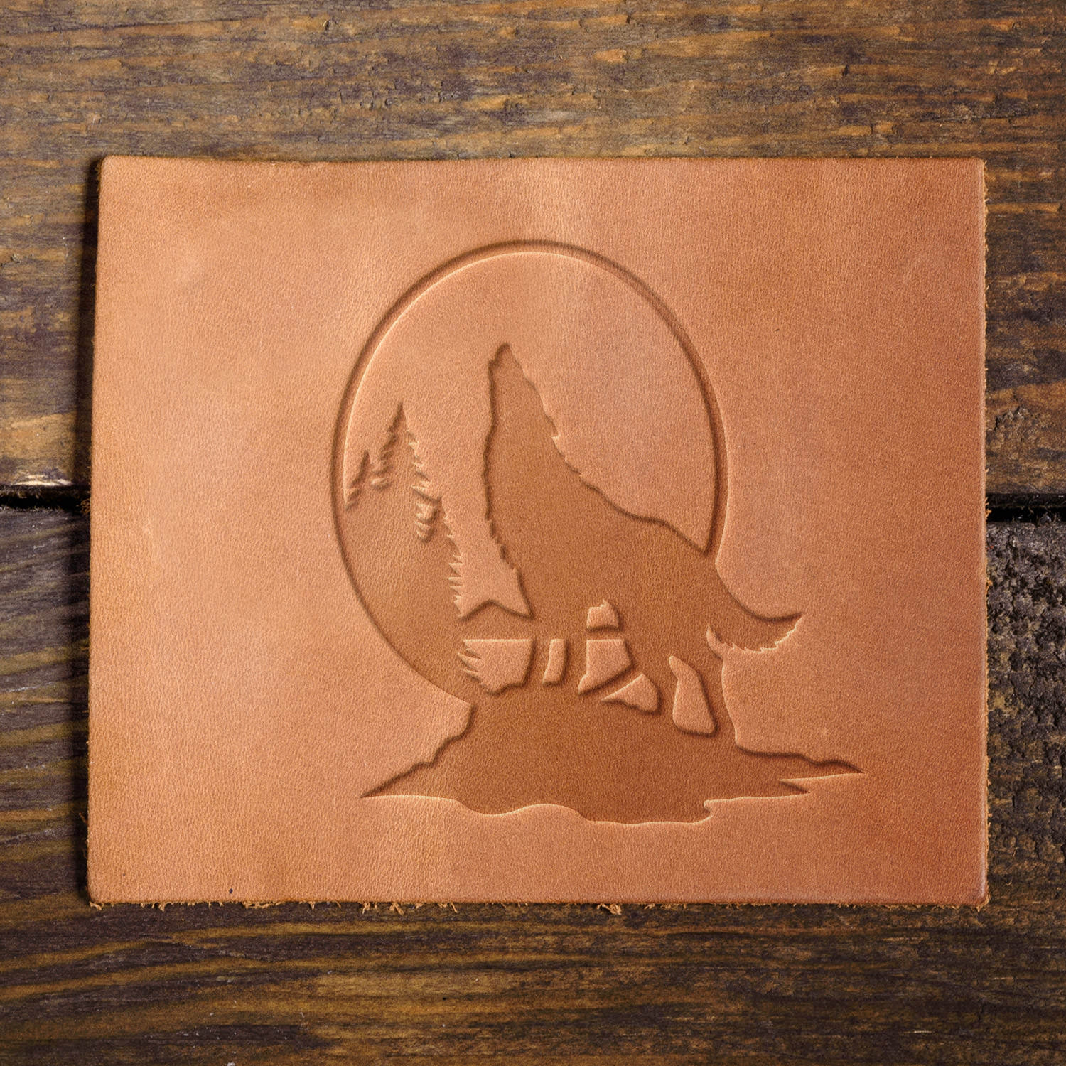 Leather sample with a bold howling wolf stamp impression, ideal for wilderness and nature-themed leathercraft.