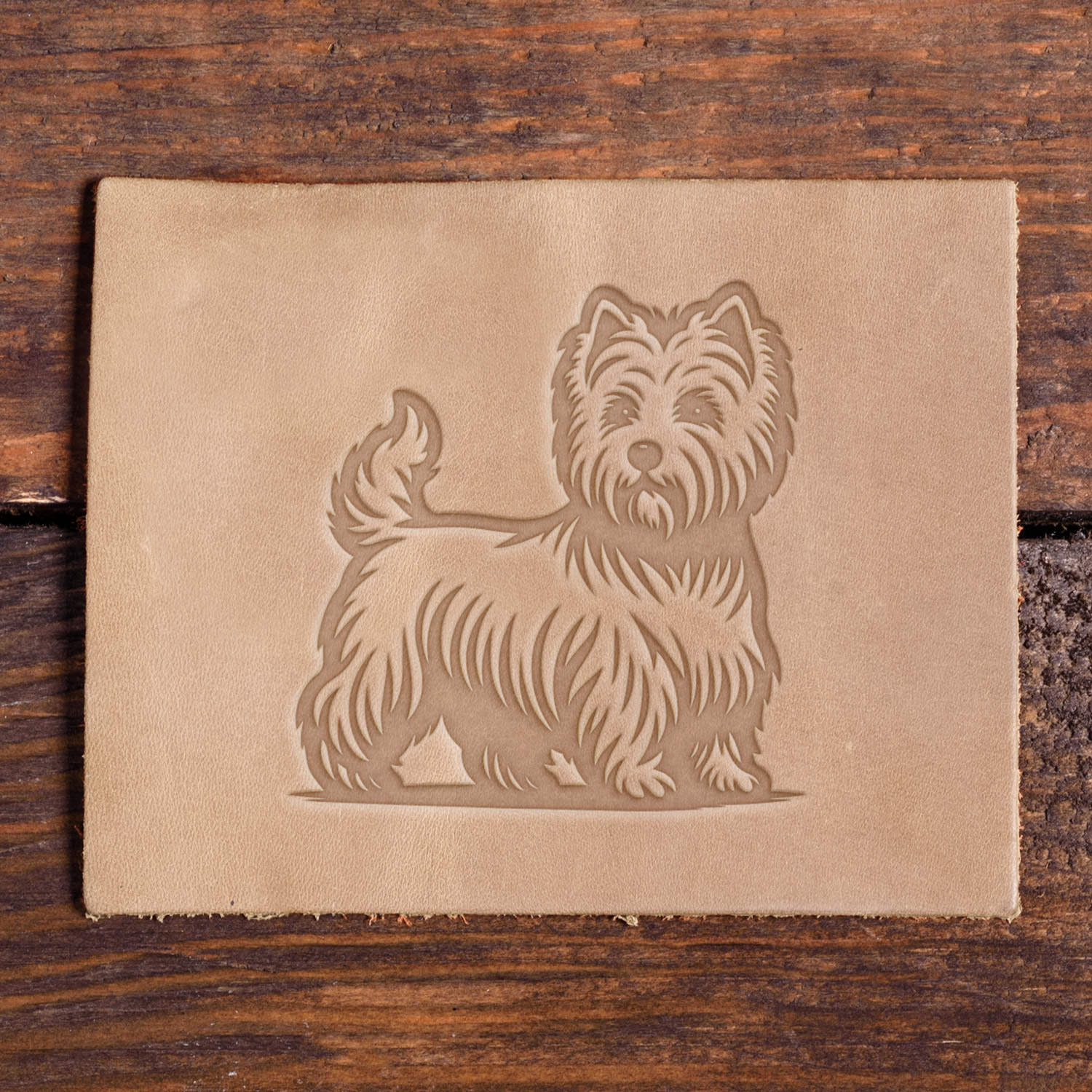 West Highland White Terrier stamped into leather using a Delrin stamp.