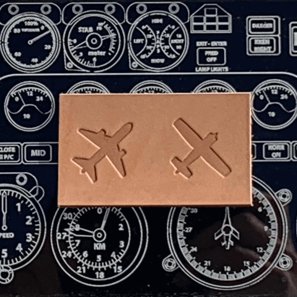 Delrin leather stamp with airplane designs stamped into vegetable-tanned leather, photographed on an aviation instrument panel background.