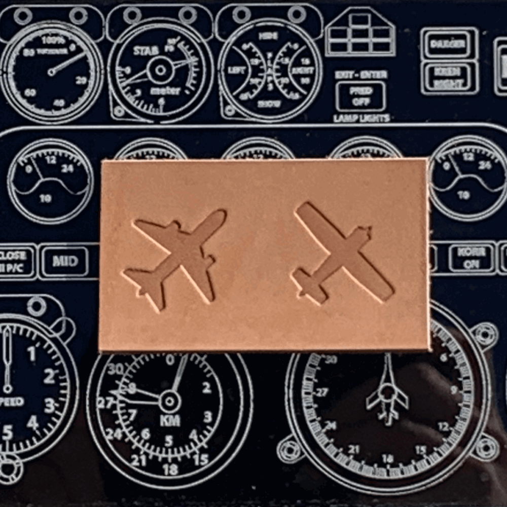 Delrin leather stamp with airplane designs stamped into vegetable-tanned leather, photographed on an aviation instrument panel background.