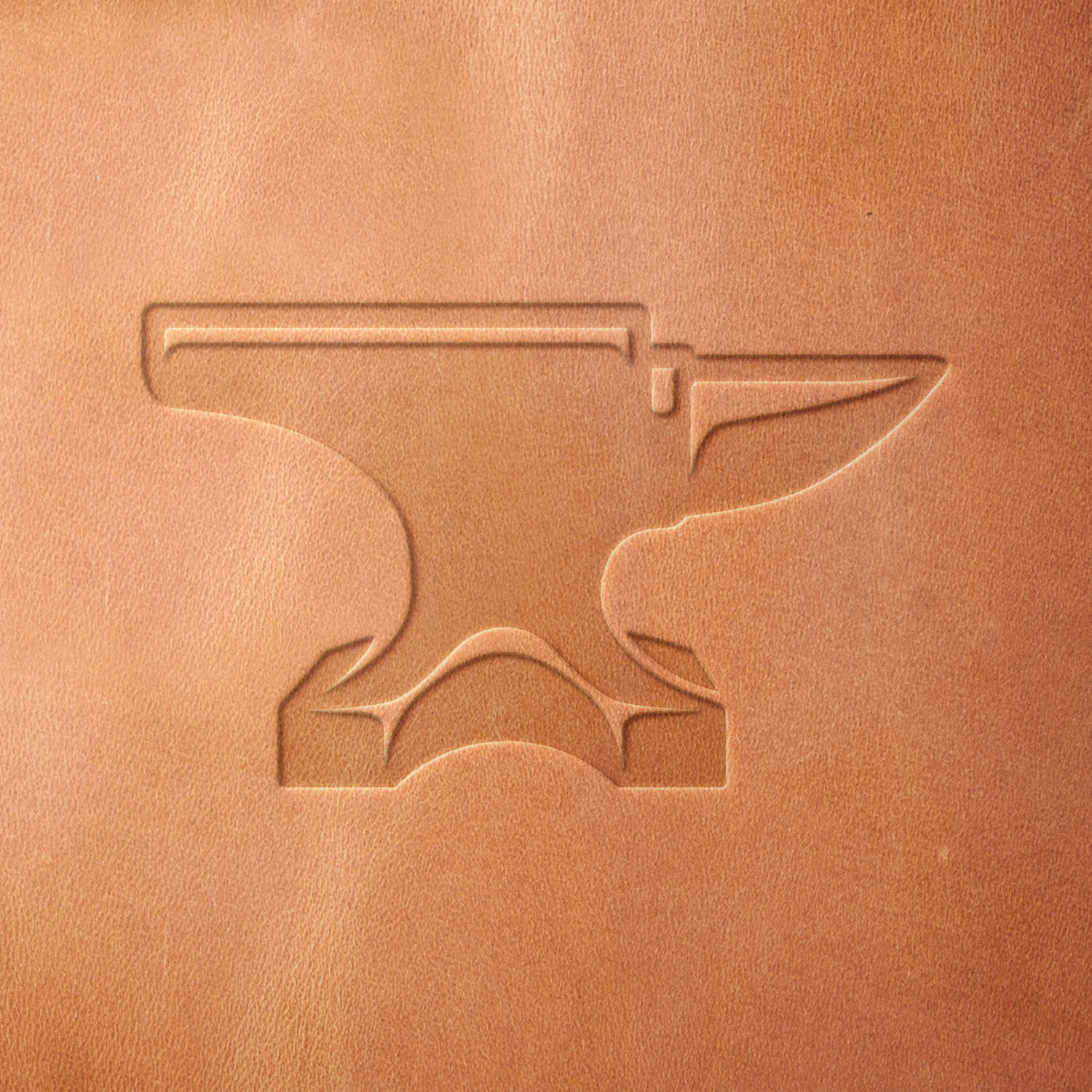 Leather sample with a stamped anvil design, created using a Delrin leather stamp—ideal for blacksmithing enthusiasts, metalworkers, and industrial-inspired leathercraft.