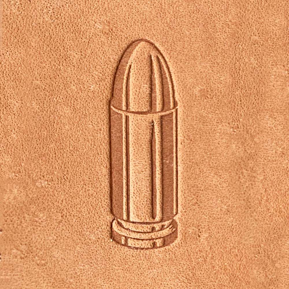 Natural veg-tan leather stamped with a bullet cartridge design using a Delrin leather stamp, showing clean edges and defined casing details.