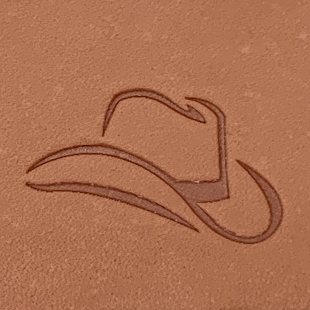 Close-up of a cowboy hat design stamped into natural veg-tan leather using a Delrin leather stamp, showing smooth lines and clean edges.