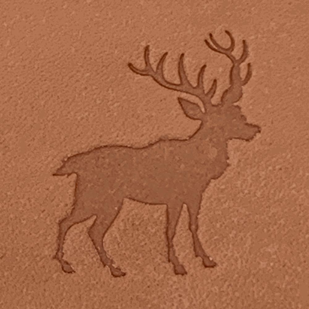 Natural veg-tan leather stamped with a stag silhouette using a Delrin leather stamp, showing strong antler detail and clean edges.