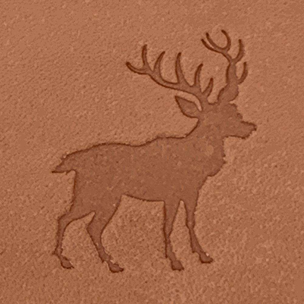 Natural veg-tan leather stamped with a stag silhouette using a Delrin leather stamp, showing strong antler detail and clean edges.