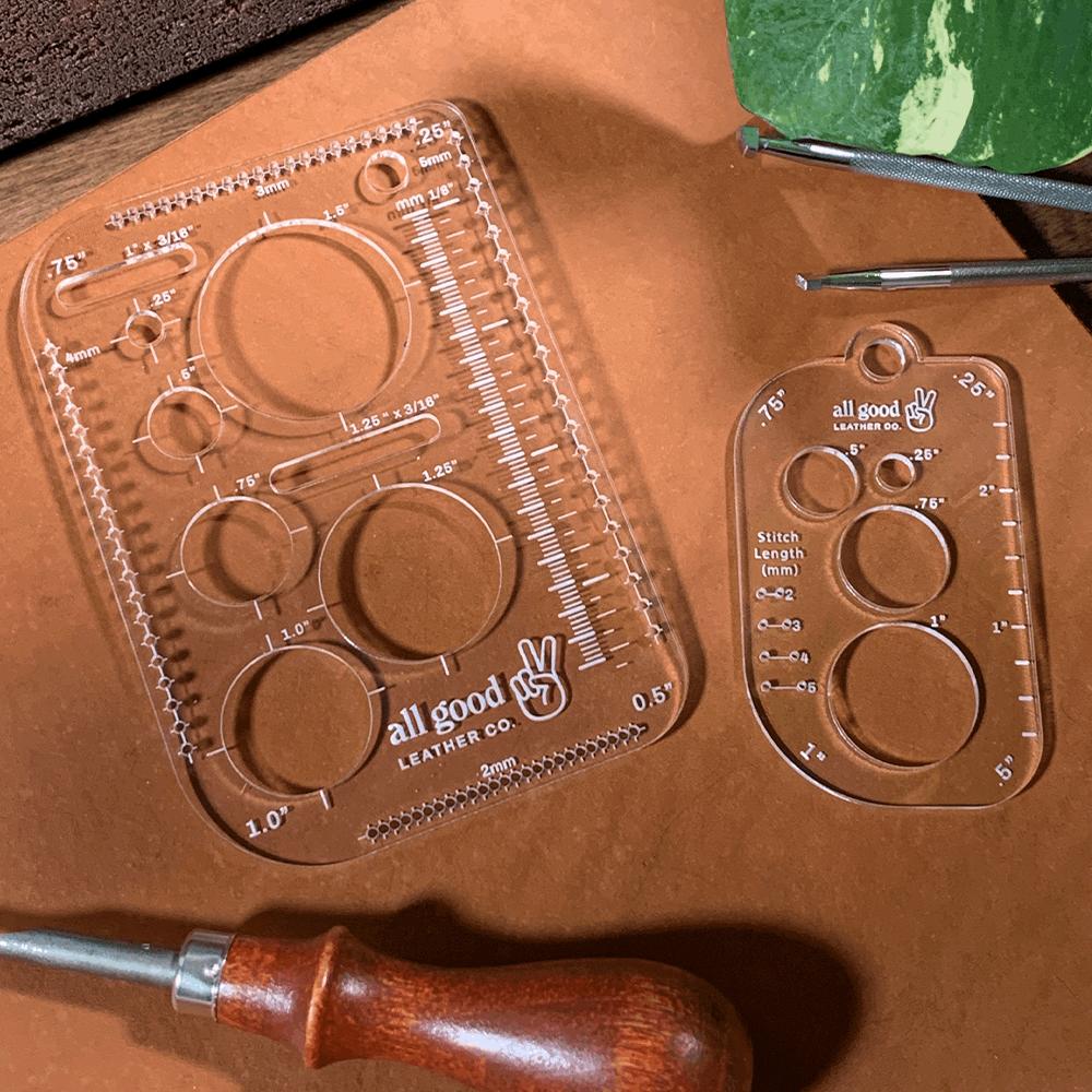 Leatherworking multi-tool resting on veg-tan leather next to an awl, showing circle stencils, rulers, and marking guides
