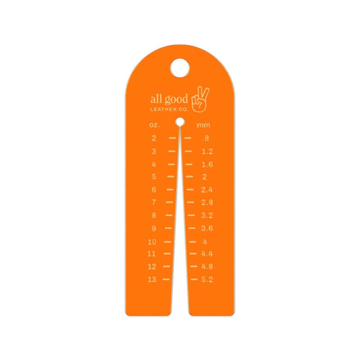 Leather thickness gauge tool made from fluorescent orange acrylic with metric and imperial markings