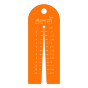Leather thickness gauge tool made from fluorescent orange acrylic with metric and imperial markings