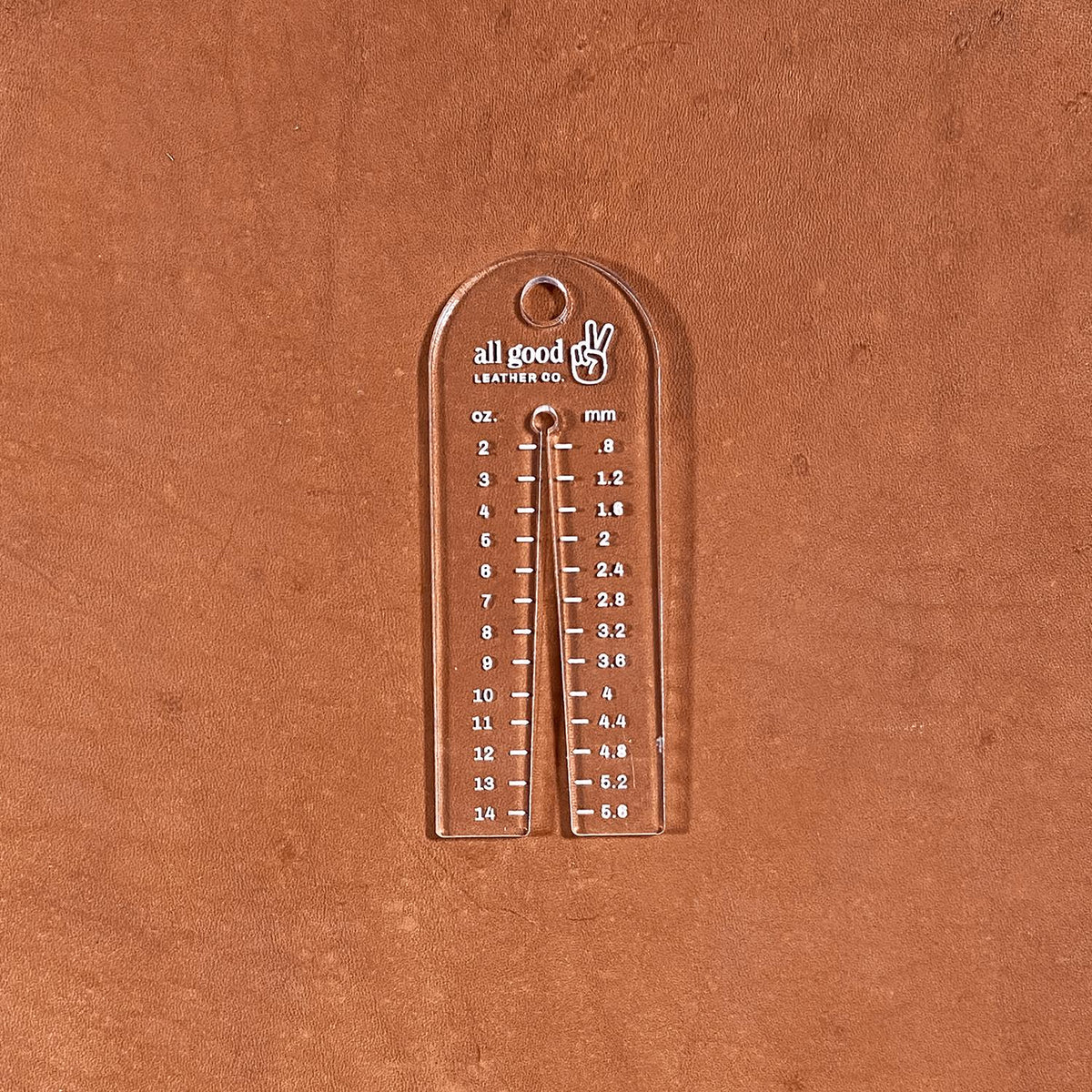 Leather thickness gauge tool shown on vegetable-tanned leather measuring hide thickness