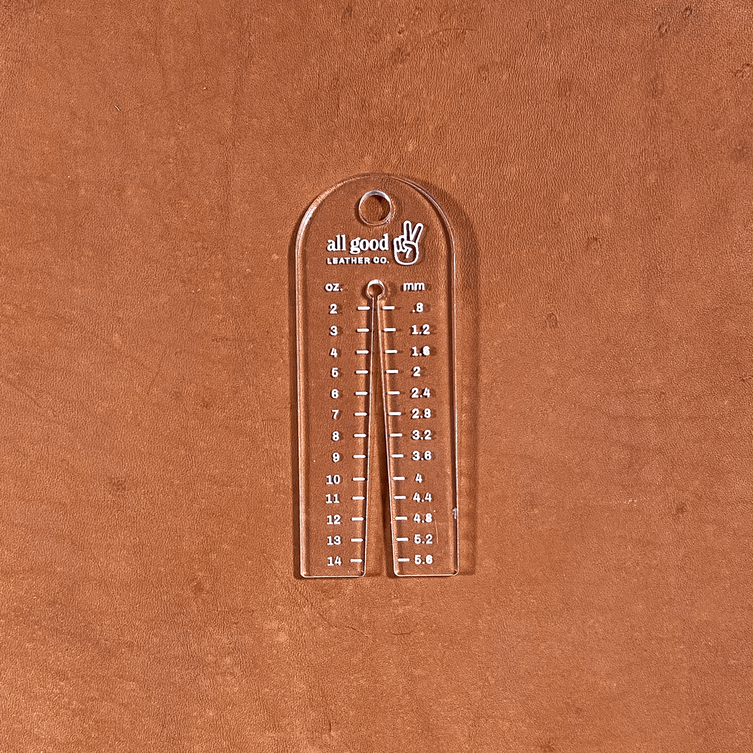 Leather thickness gauge tool shown on vegetable-tanned leather measuring hide thickness
