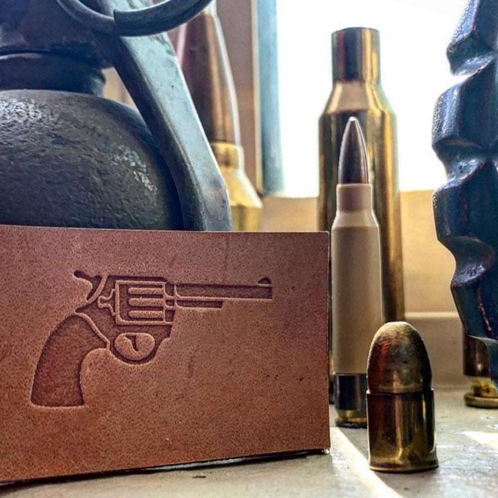 Stamped impression of a classic revolver handgun made with a Delrin leather stamp on natural veg-tan leather.
