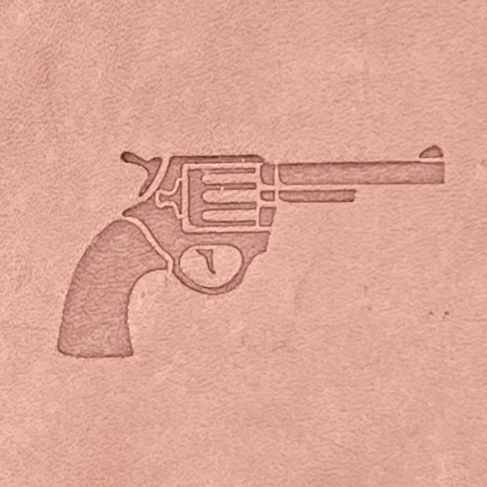 Stamped impression of a classic revolver handgun made with a Delrin leather stamp on natural veg-tan leather.