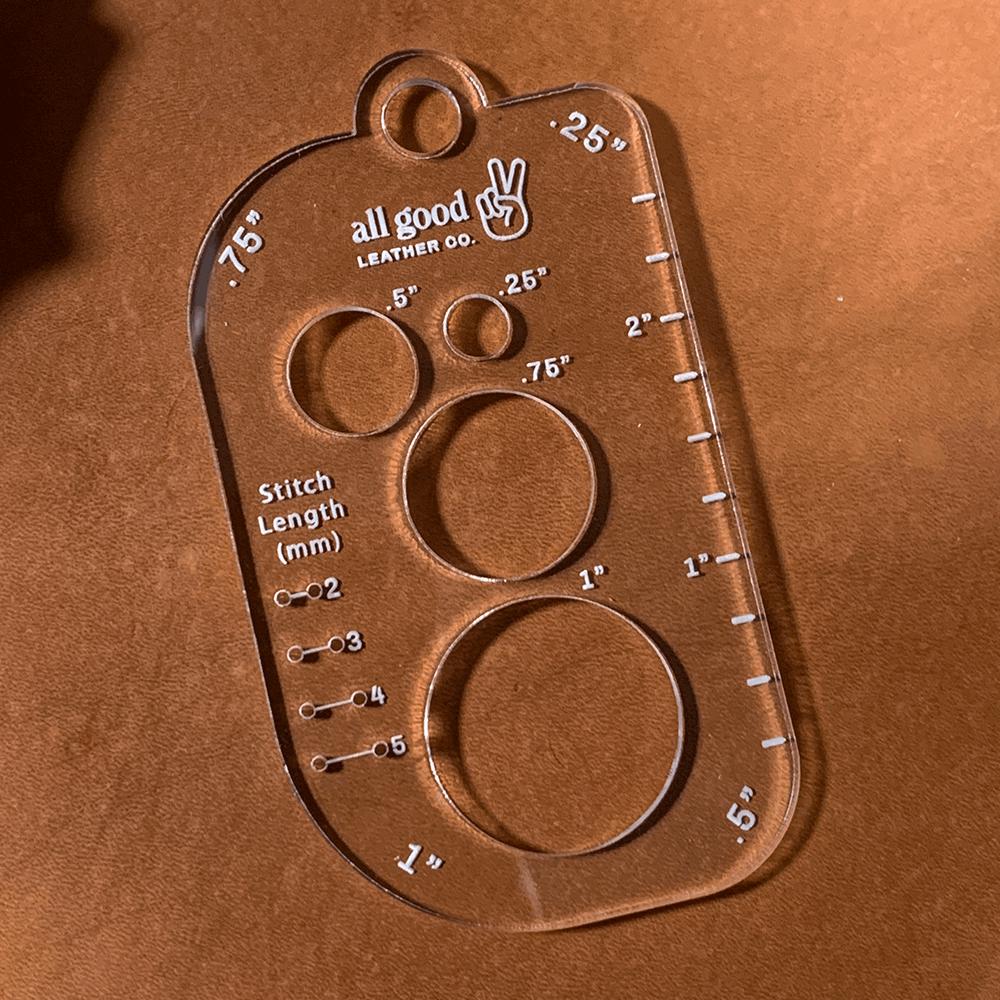 Leatherworking multi-tool shown on veg-tan leather with stitched holes and layout markings