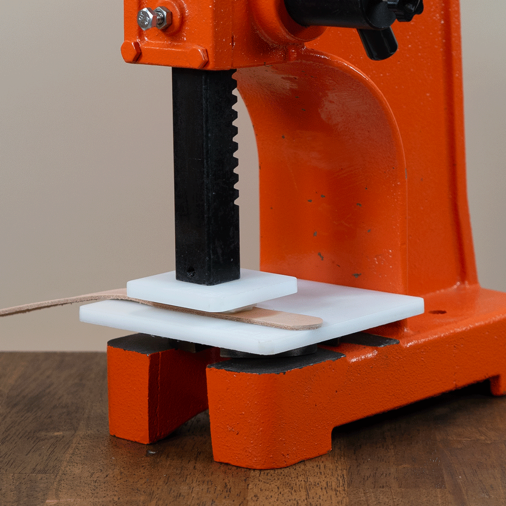 Acrylic press plates used with an arbor press to evenly apply pressure while stamping leather